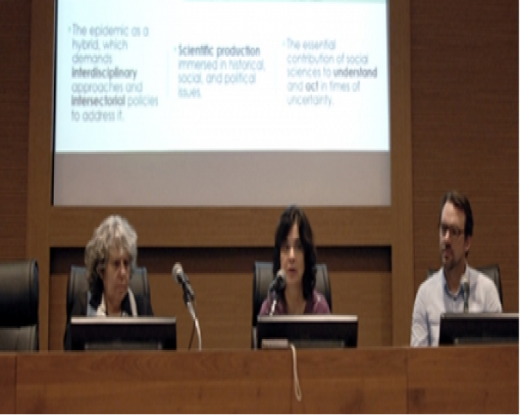 Duas mulheres e um homem sentados para apresentação de seminário